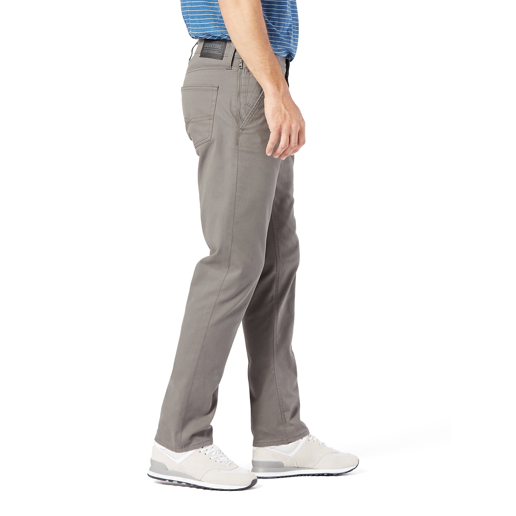 Person wearing gray Levi S67 Hybrid Chinos pants on a white background