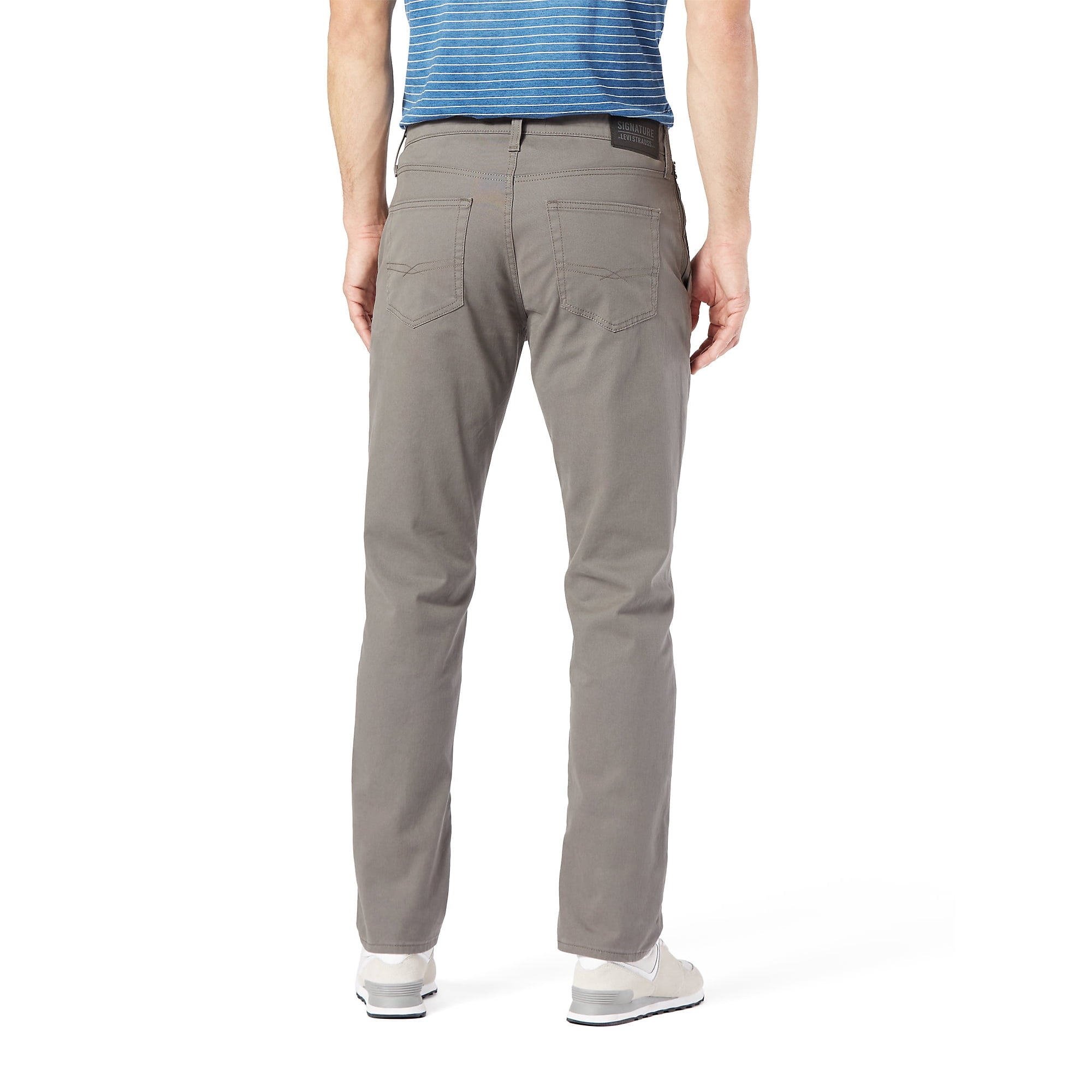 Person wearing gray Levi S67 Hybrid Chinos pants on a white background