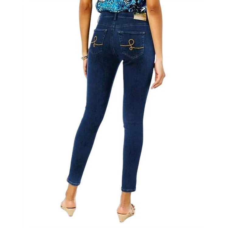Person wearing dark blue Lilly Pulitzer jeans on a white background
