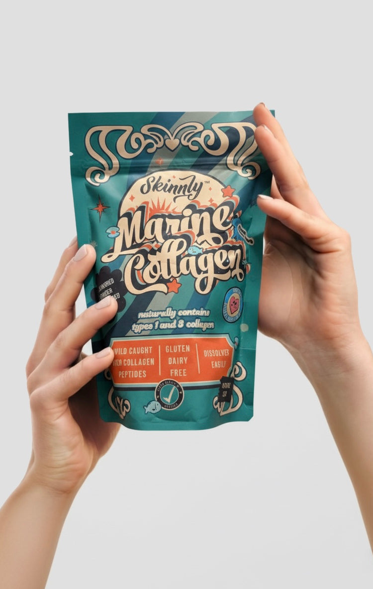 Skinnly Marine Collagen Powder being held up by a hand against a white background - formatted for mobile devices.
